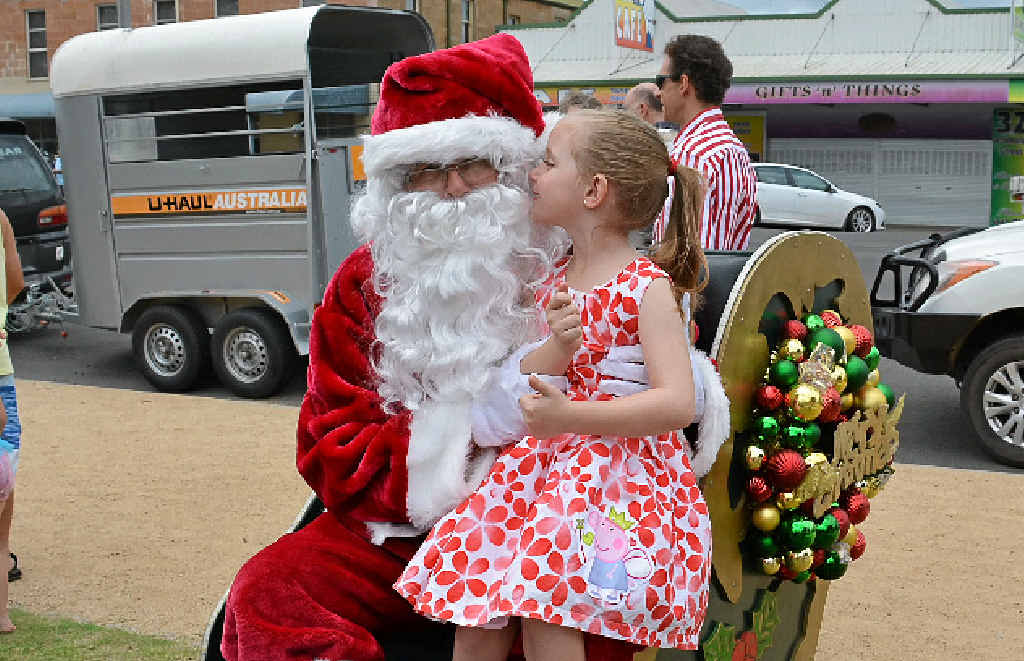 Jasmine O’Neil whispers her Christmas wish to Santa.